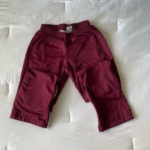 Maroon Varsity Spirit pants with white zipper detailing on the calves size small